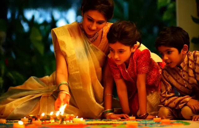 Lady Children Celebrating Deepavali with Diyas