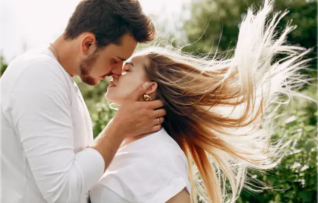 Couple Kissing in White Dress with Open Hairs of Girl